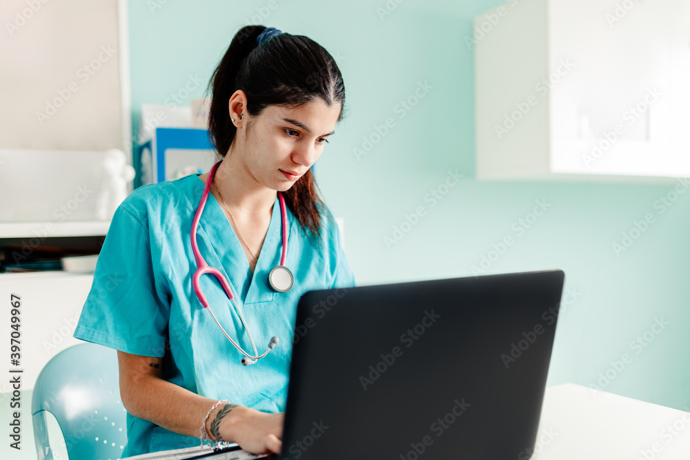 Female doctor using the laptop in the clinic Female doctor using the laptop in the clinic