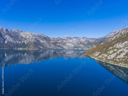 Beautiful fjord of Montenegro. Calm in the Bay of Kotor. Reflection of mountains on water.