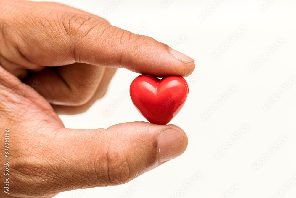 Fototapeta premium Little Heart in hand of old man. heart disease, Heart Disease Prevention, Health care 