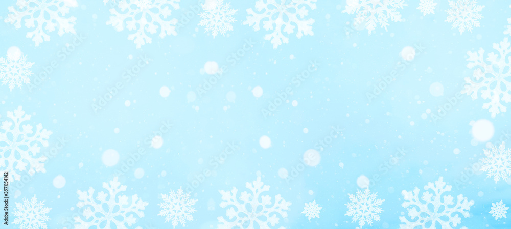 snowflakes and ice crystals isolated on blue sky - winter background banner