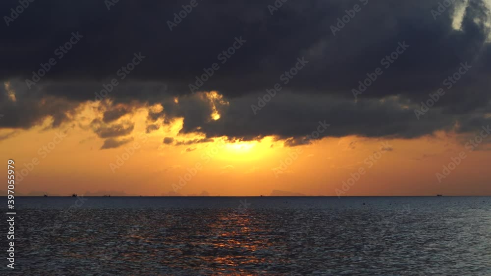Beautiful sunset over the sea water on the island of Koh Phangan, Thailand. Travel and nature concept. Evening sky, clouds, sun and sea water Beautiful sunset over the sea water on the island of Koh Phangan, Thailand. Travel and nature concept. Evening sky, clouds, sun and sea water