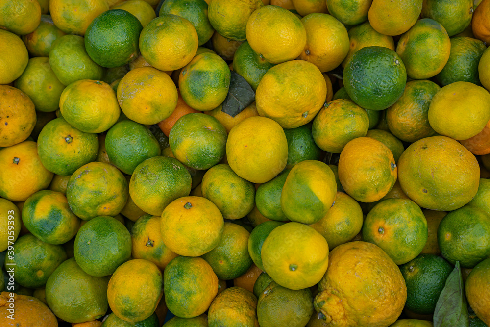 yellow and green tangerines lie in a box yellow and green tangerines lie in a box