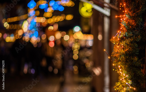 Light night bokeh city blur. Christmas illumination. Festive Christmas fair, winter, new year concept. Abstract background.