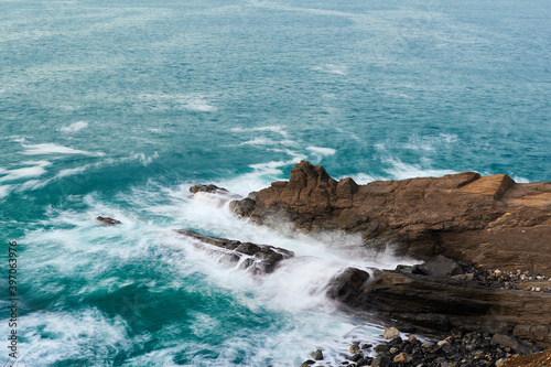 Long exposure of waves breaking over the rocks
