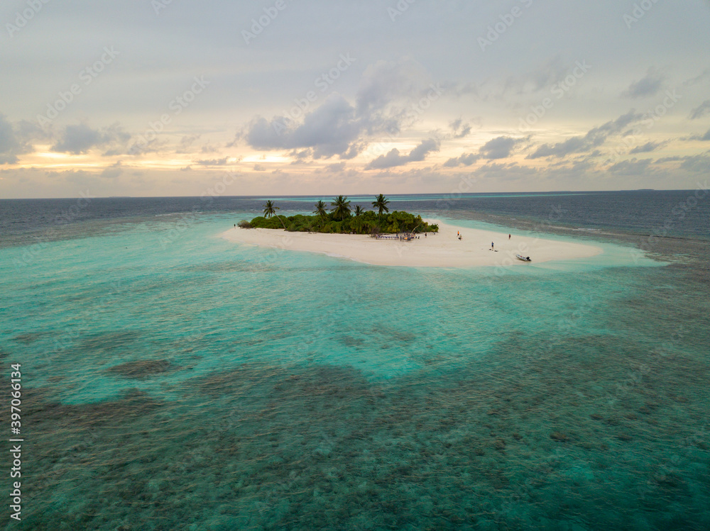 Aerial spherical panorama of tropical paradise beach on tiny Maldives island during sunset. Turquoise ocean, white sand, coconut palm trees.