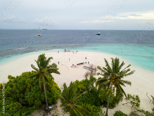 Aerial spherical panorama of tropical paradise beach on tiny Maldives island. Turquoise ocean  white sand  coconut palm trees.