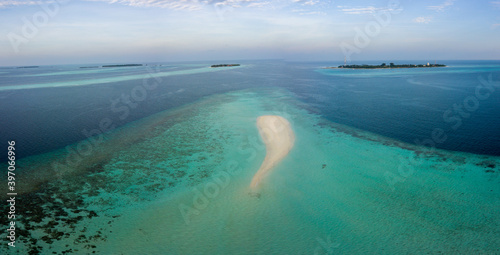 Aerial spherical panorama of tropical paradise beach on tiny Maldives island. Turquoise ocean, white sand, coconut palm trees.