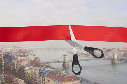 Sale of airline tickets. The end of the quarantine of the coronavirus pandemic, the beginning of travel. Scissors cut a red ribbon overlooking the Danube River in Budapest, Hungary