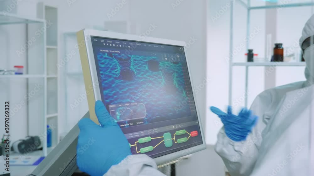 Chemists in protection suit discussing about changes in vaccine composition in equipped lab pointing desktop. Doctors examining virus evolution using high tech researching diagnosis against covid19 Chemists in protection suit discussing about changes in vaccine composition in equipped lab pointing desktop. Doctors examining virus evolution using high tech researching diagnosis against covid19