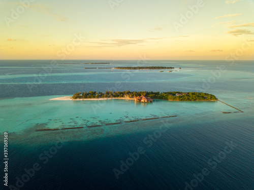 Aerial spherical panorama of tropical paradise beach on tiny Maldives island during sunset. Turquoise ocean  white sand  coconut palm trees.