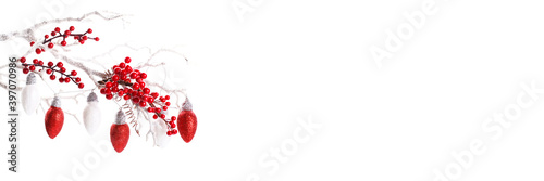 Fototapeta Naklejka Na Ścianę i Meble -  Red and white Christmas ornaments on snowy tree branch