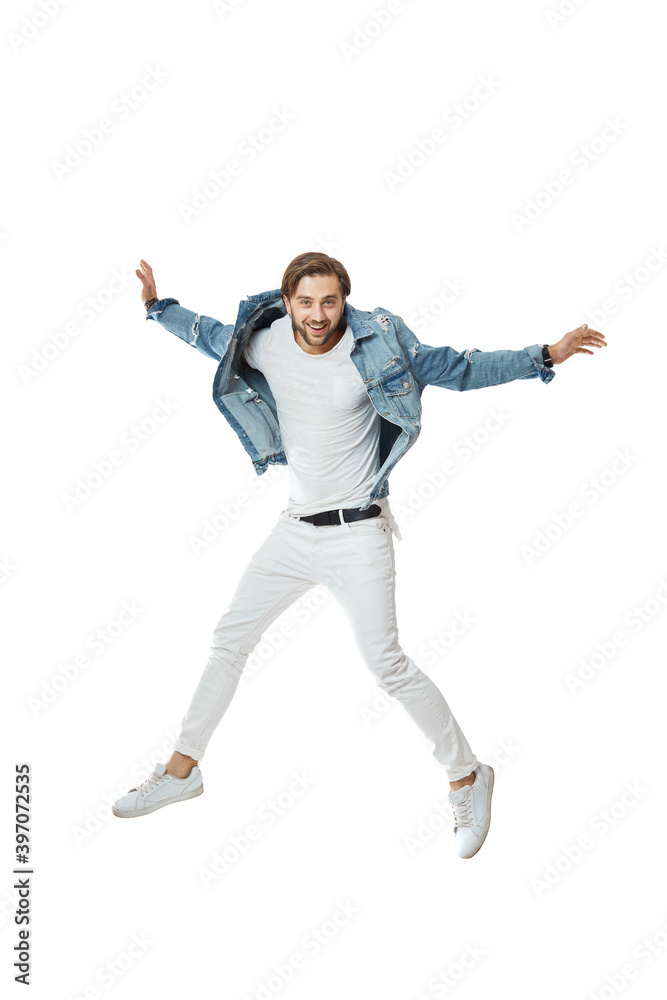 attractive crazy man in denim t-shirt jeans jumping high isolated on white background