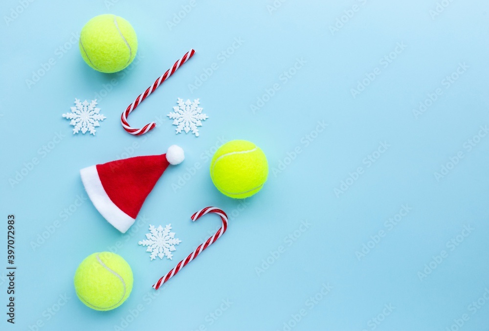 Santa hat , tennis balls , candy canes and snow flakes on blue