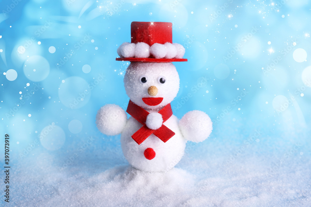 Cute decorative snowman on light blue background, bokeh effect