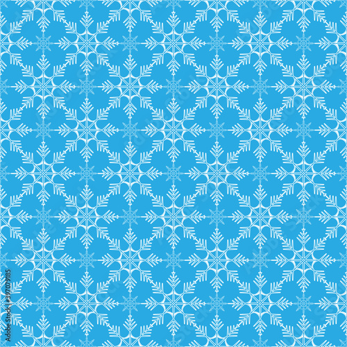 Seamless vector winter pattern of snowflakes on a blue background