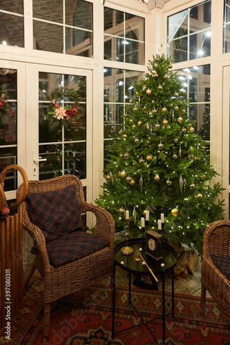 Home Christmas decoration interior late in night with light on xmas tree and gifts. © Vladimir Koshkarov