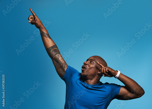 Black man celebrating victory in studio portrait