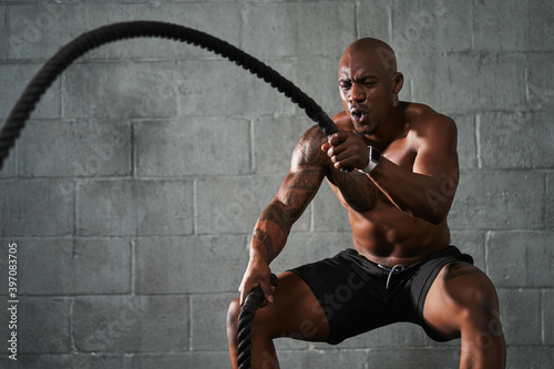 Black man doing intense sports training photo