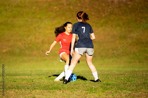 Young girls playing soccer scrimmage game