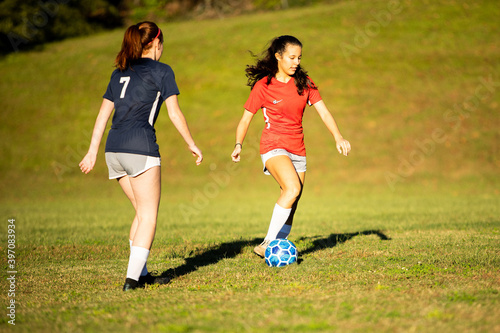 Young girls playing soccer scrimmage game