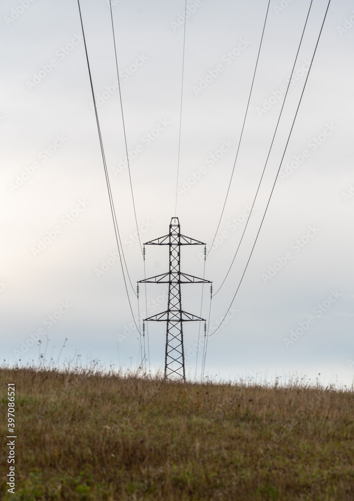 High voltage line in the fields, under overcast weather