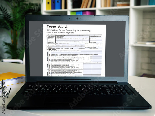  Financial concept about  Form W-14 Certificate of Foreign Contracting Party Receiving Federal Procurement Payments  with inscription on the sheet.