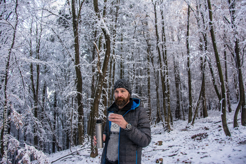 Man holds a cup in the forest Man holds a cup in the forest