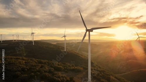 Scenic Aerial view of wind turbines farm in sunset time. High quality 4k footage
