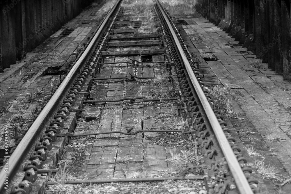 an abandoned train track pictured in black and white