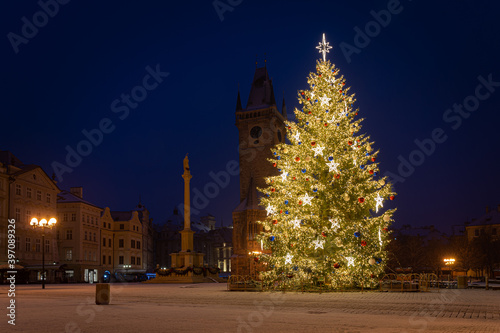 Photography Christmas tree and the Old Town Square in Prague, Czech Republic, covered by fresh snow