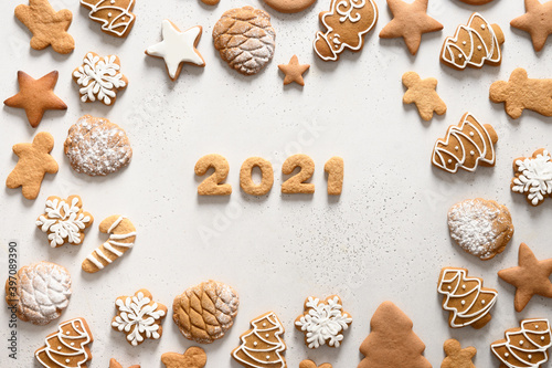 Christmas handmade cookies arranged around date 2021 on white background. Merry Christmas. View from above. Flat lay.