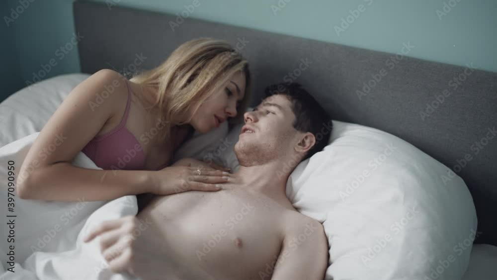 Sexy couple making love in bedroom. Handsome man kissing woman in bra. Attractive couple having foreplay in bed. Sensual couple enjoying romantic time together at hotel. Erotic or intimacy concept. Sexy couple making love in bedroom. Handsome man kissing woman in bra. Attractive couple having foreplay in bed. Sensual couple enjoying romantic time together at hotel. Erotic or intimacy concept.