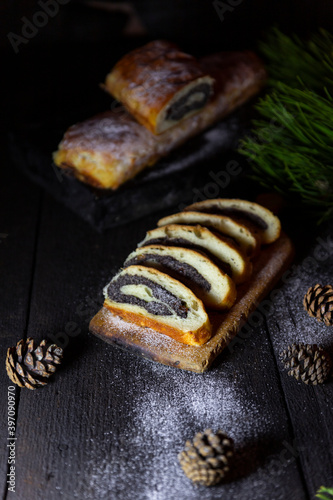 Poppy seed strudel on wooden rustic table. Traditional christmas strudel or Roll cake