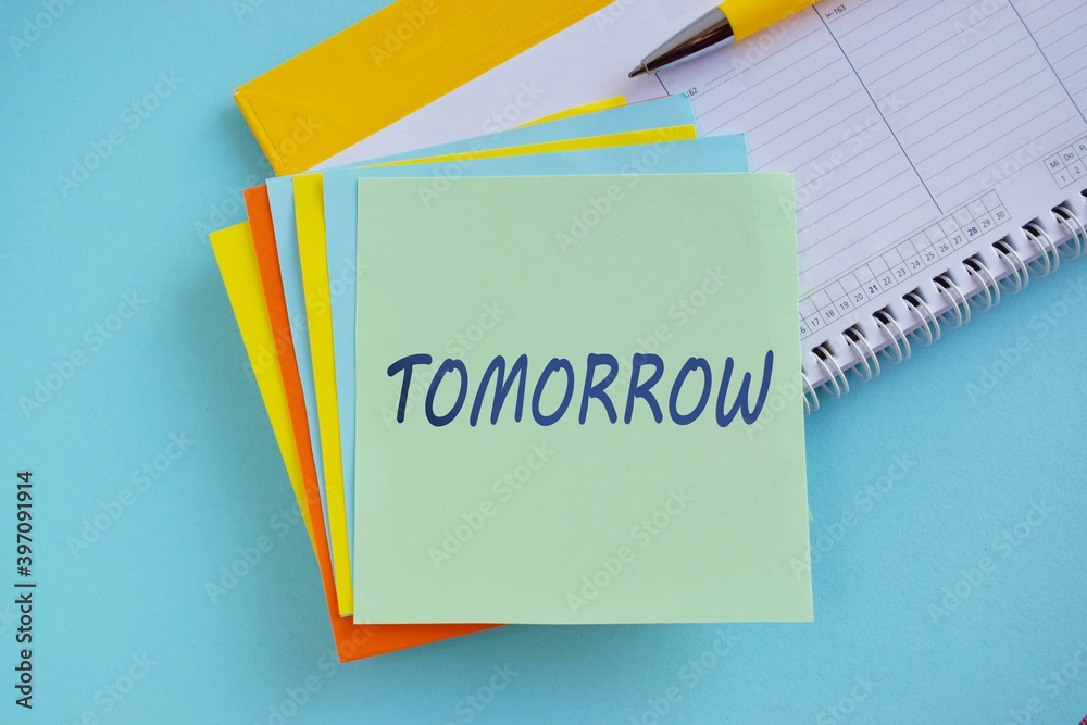 Procrastination, delay and urgency concept. Bad time management. Word TOMRROW on colorful sticky note. Procrastination, delay and urgency concept. Bad time management. Word TOMRROW on colorful sticky note.