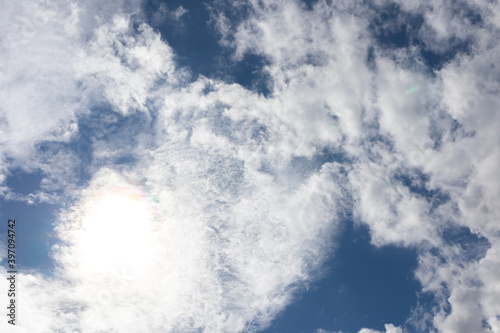 Beautiful blue clear sky with white clouds background in sunny day and copy space. Nature bright sky background image. Summer blue sky with sunlight. Texture for Design. Natural cloudy Wallpaper.