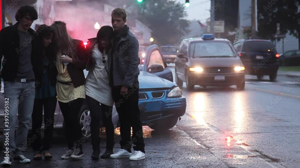 Caucasian friends stumbling after car crash