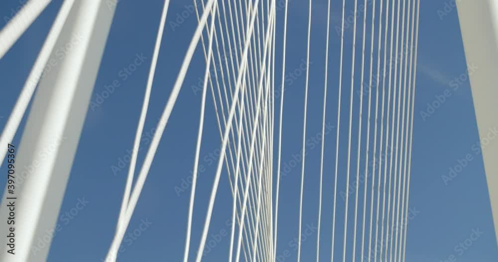 Low angle view of suspension bridge under blue sky Low angle view of suspension bridge under blue sky