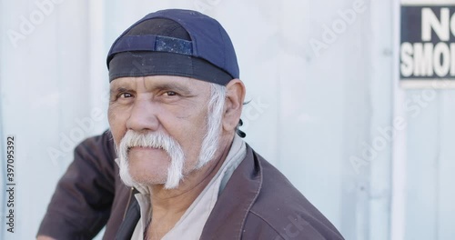 Portrait of serious older worker looking at camera photo