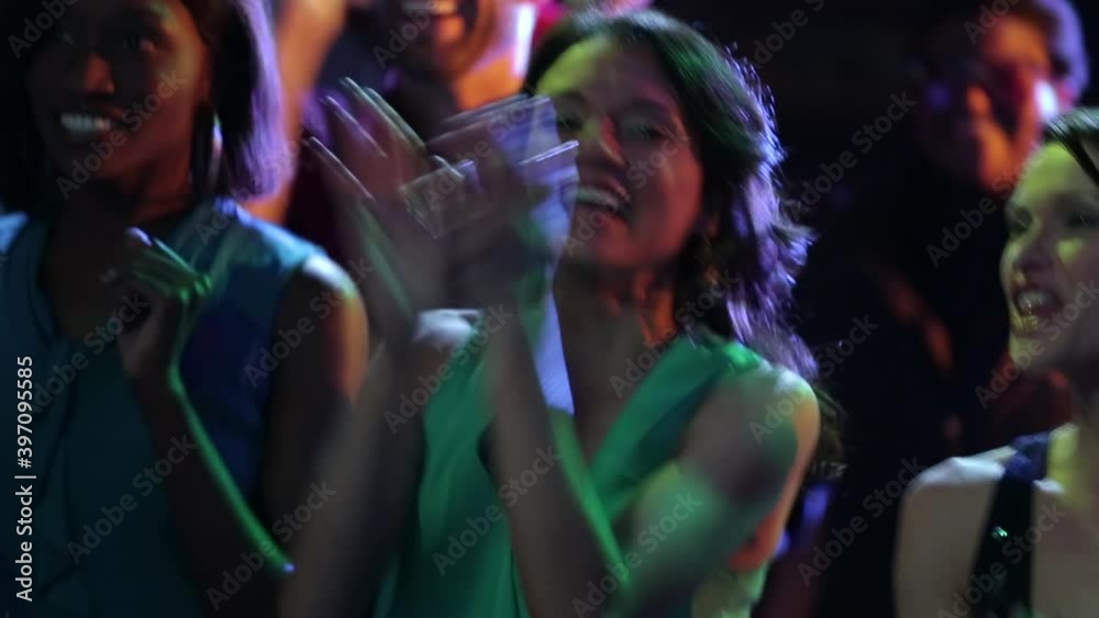 Crowd dancing and singing at music concert