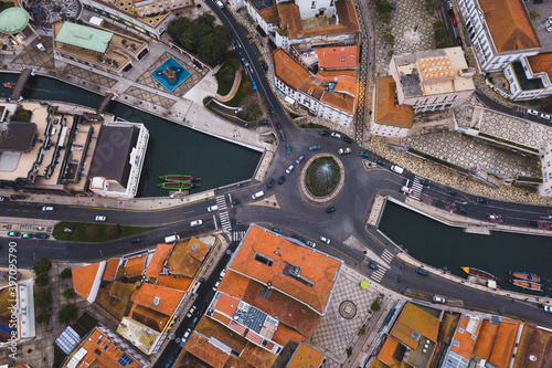 drone shot aerial view from above look Aveiro Portugal cloudy day city center rooftops orange red Monumento ao Marnoto e à Salineira
