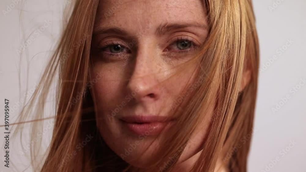 Close up of woman with hair blowing in wind