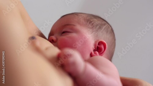 Caucasian mother breastfeeding baby daughter