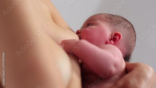 Caucasian mother breastfeeding baby daughter