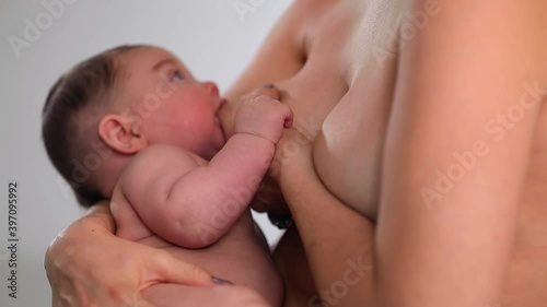 Caucasian woman breastfeeding baby daughter