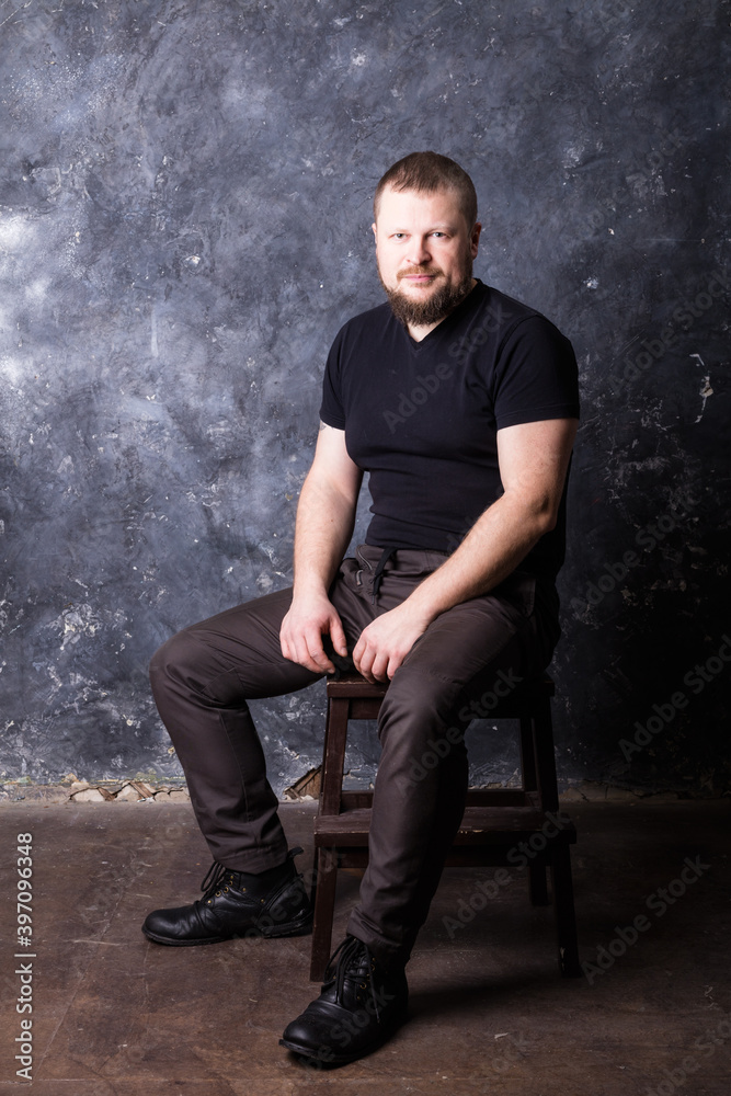 Solid bearded man dressed in t-shirt studio portrait Solid bearded man dressed in t-shirt studio portrait