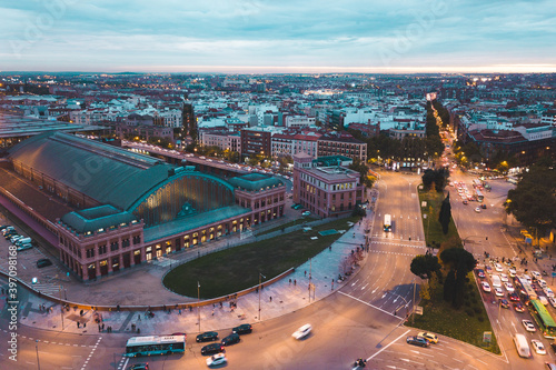 look from above view aerial drone shot Spain Madrid capital cloudy evening buildings lamps traffic Estación del Arte