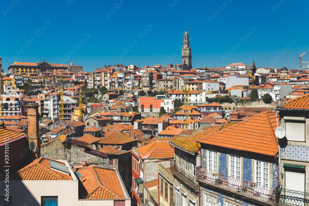 Porto Portugal old houses building colorful roofs rooftops orange red tower crossblue sky daylight sunny ajulejos streets 