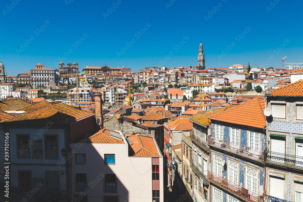Porto Portugal old houses building colorful roofs rooftops orange red tower crossblue sky daylight sunny ajulejos streets 