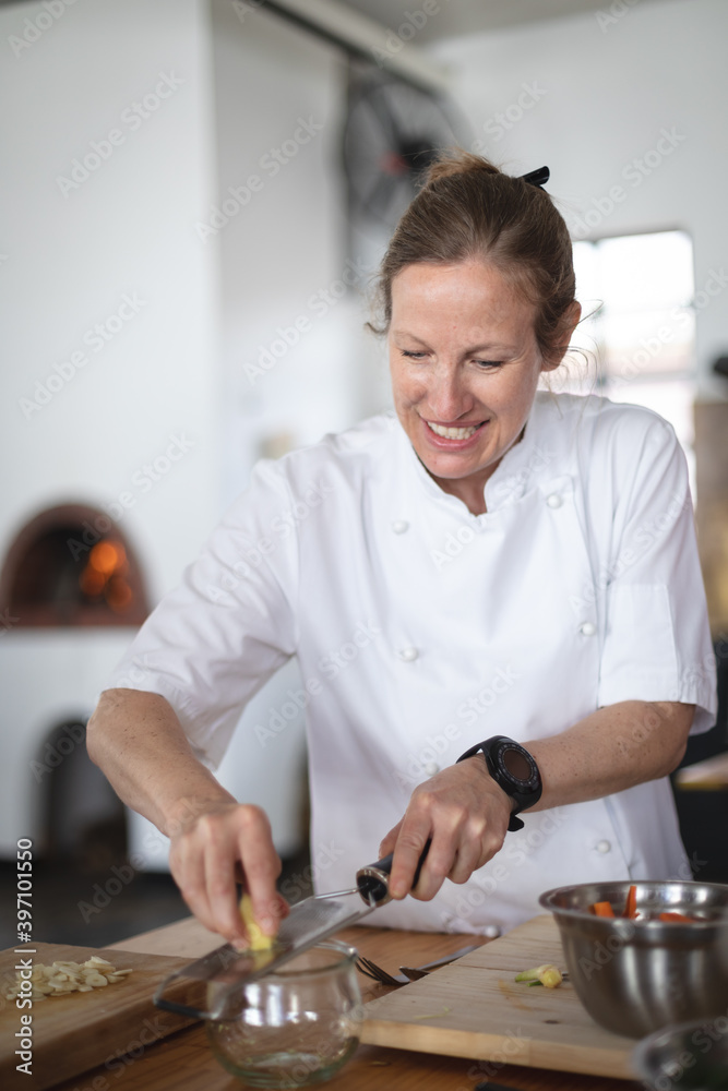 Caucasian female chef cooking in kitchen Caucasian female chef cooking in kitchen
