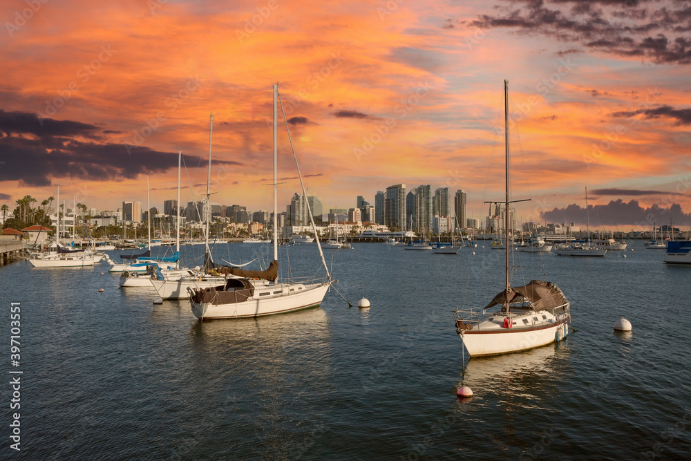 Downtown towers and peaceful marina with sunset sky in scenic San Diego, California.